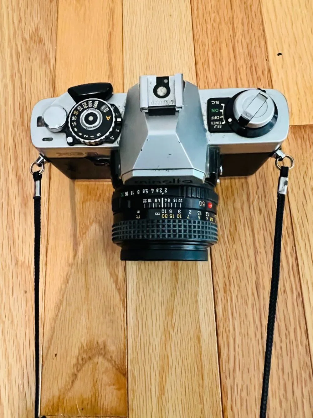 vintage Minolta XG-9 35mm SLR film camera equipped with a 50mm prime lens